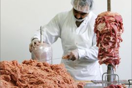 A worker piles meat on a stick in a Kebab production hall in Berlin September 5, 2006. A Kebab producer opened his doors to the media on Tuesday to show his production place
