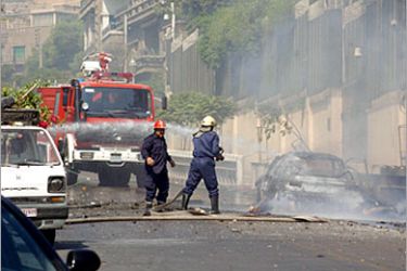 epa00816265 Firemen extinguish a burning car outside the US embassy in Damascus , Tuesday, 12 September 2006. Three men trying to attack the US embassy in Damascus