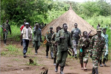 AFP - A column of around 40 Lord's Resistance Army (LRA) fighters emerge from thick bush 20, September 2006 at Ri-Kwangba on southern Sudan's border with the Democratic