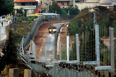 f_A Israel Humvee (R) patrols the Jewish state's side of border in south Lebanon at an area known as Fatima Gate, 27 October 2006. Hard against Lebanon's "Blue Line", at the point known as position 6-50,
