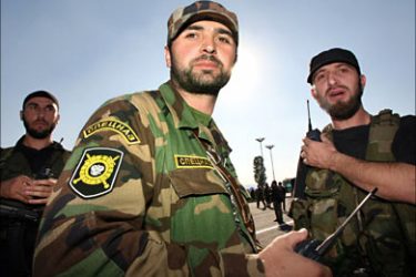 r_Security personnel keep watch during the re-opening of Grozny airport on October 5, 2006. Ramzan Kadyrov, the feared strongman whose personal militia police Chechnya on