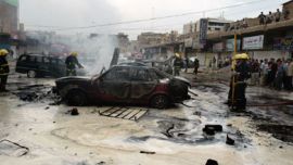 Iraqi firefighters douse the fire that swept over vehicles at the site where a car bomb exploded in central Baghdad 14 October 2006. Gunmen murdered a family of 10, including five women and three children,
