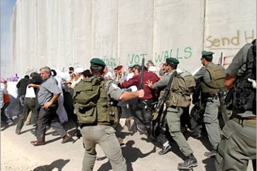 AFP - Israeli border guards disperse 13 October 2006 Palestinians protesting at a check point integrated into the Israeli controversial separation barrier, on the outskirts of the West