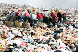 REUTERS /Garbage collectors look for waste to recycle at a garbage dump site in Sanya, China's Hainan province, October 17, 2006. Growing populations and booming economies are