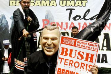 A Muslim cleric hits a mask of US President George W. Bush worn by a protester during a rally in Bogor, 11 November 2006. Hundreds of protesters from Indonesia's of Hizbut Tahrir held a peaceful demonstration against the planned visit of President Bush to Indonesia on November 20.