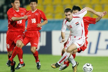 Syrian midfielder Mahmoud Almna (2nd R, #8) dribbles the ball among North Korean players during their Asian Games Round 2 Group F football match at the Qatar Sports Club Stadium in Doha, 29 November 2006.