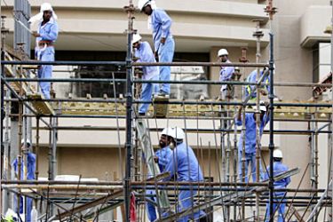REUTERS /Foreign workers are seen at a construction site in Dubai, United Arab Emirates, November 13, 2006. The United Arab Emirates should crack down on employers abusing the