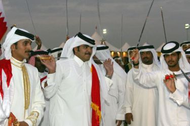 epa00869804 (L-R) H H Sheikh Nasser Bin Khalifa (far Left) and The torch relay Ambassador H E Sheikh Joaan Bin Hamad Al Than 2nd from the left) join in the dance celebrations in Manama,Bahrain