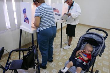 AFP/Thirteen-month old Mathew Ward waits in a stroller as his grandparents Magdalena and Samuel Moreno vote in the midterm elections 07 November 2006 at a polling station in Los Angeles.