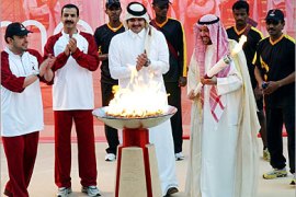 . AFP / The president of the Asian Olympic Council, Sheikh Ahmad al-Fahad al-Sabah (R) of Kuwait, holds the torch of the Doha Asian Games after lighting it in the presence of the head of