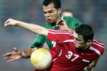 Haidar Hantush (back) of Iraq vies with Syria's Abdul Fattah al-Agha during their Group B first round Football match in the 15th Asian Games 2006 in Doha,