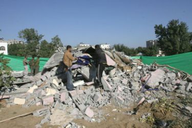 Palestinians inspect the rubble of a destroyed house in the Jabalia refugee camp in the northern Gaza Strip following the Israeli air raid, 10 November 2006.
