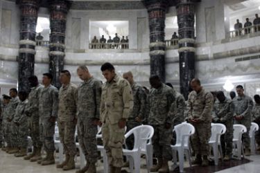 US soldiers pause for a moment of prayer moments before becoming US citizens during a naturalization ceremony held in one of ousted Iraqi dictator Saddam Hussein's former