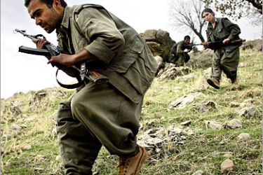 AFP / PKK guerillas take positions as they storm a hilltop during military exercises in the mountains of northern Iraq's Kurdish autonomous region, 18 November 2006. High in the