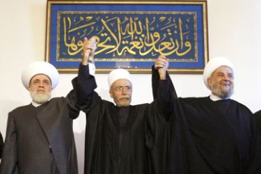 Muslim Sunni Mufti Sheikh Mohammad Rashid Kabbani (L) holds hands with highest religious Druze Sheikh Naem Hassan (C) and Shiite Mufti Sheikh Abdel Amir Kabalan (R)