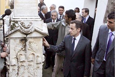 AFP / French Interior Minister Nicolas Sarkozy (2ndR) touches a memorial tomb in the French-Jewish 'Bologhine' cemetery, in central Algiers, Algeria, 13 November 2006. Sarkozy 13