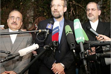 AFP / Iranian Supreme National Security Council Secretary Ali Larijani (C) and his unidentified colleagues speak to journalists after his meeting with Russian Security Council
