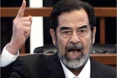 AFP / Former Iraqi President Saddam Hussein yells at the court as he receives his verdict during his trial held under tight security in Baghdad's heavily fortified Green Zone, 05