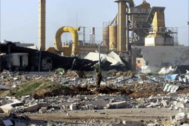 A Palestinian man inspects a destroyed factory after Israeli troops pulled out of the northern Gaza Strip November 26, 2006. A ceasefire began in the Gaza Strip on Sunday, heralding a possible end to Palestinian rocket attacks on Israel and a halt to a crushing Israeli military offensive.