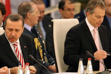 Turkish President Recep Tayyip Erdogan (C) talks to Turkish Foreign minister Abdullah Gul (L) next to British Prime Minister Tony Blair prior to th start of the Nato Summit working session in Riga, Latvia,