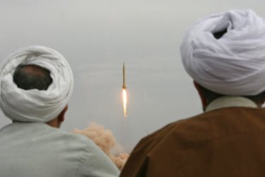 AFP/Iranian clergymen watch a Shahab-3 long-range ballistic missile fird by Iran's Revolutionary Guards in the desert outside the holy city of Qom, 02 November 2006.