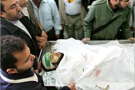 AFP- Palestinians carry the body of Ahmed Saadat into a hospital in Beit Lahia 01 November 2006. Saadat was killed during an Israeli incursion into the northern Gaza Strip. Four