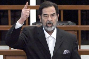 Former Iraqi President Saddam Hussein yells at the court as he receives his verdict during his trial held under tight security in Baghdad's heavily fortified Green Zone,