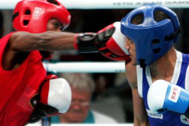 AFPEast Timorese boxer Yeferdson Issac Ramos punches Saudi Arabia's Ali Al-Ahmry in their light fly 48kg preliminary bout during the 15th Asian Games in Doha, 04 December 2006. Saudi Arabia won with 32:16 points. AFP