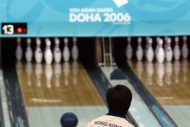 afp/ TO GO WITH STORY BY TRUDY HARRIS Janet Lam of Hong Kong watches her ball during the Asian Games 2006 bowling women's singles competition at the Qatar Bowling Centre in Doha, 03 December 2006. China might dominate most sports at these Asian Games but down at the ten pin blowing alley, it's the Philippines, Indonesia and their southern neighbours who rule the roost. AFP PHOTO / TOSHIFUMI KITAMURA