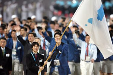 f_The Korean Unification flag is carried in front of the joint North and South Korean athletic delegation during the 15th Asian Games in Doha, 01 December 2006. After years of planning and billions of dollars in investment, the Asian Games officially opened in the Qatari capital Doha with what is being billed as the most spectacular gala ceremony ever seen, with more than 13,000 athletes from 39 countries angling for gold in 45 events. AFP PHOTO / TOSHIFUMI KITAMURA