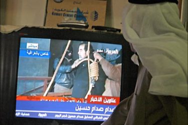 f_A Kuwaiti follows former Iraqi leader Saddam Hussein's execution on TV in Kuwait City 30 December 2006. Kuwaitis welcomed the hanging of Saddam Hussein today