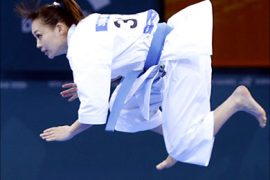 f_Japanese Nao Morooka floats in the air in the women's individual kata Karate final during the 15th Asian Games in Doha, 12 December 2006. Japan beat Vietnam for the gold medal. AFP PHOTO / ROSLAN RAHMAN