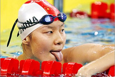 . REUTERS /China's Zhou Yafei reacts after the women's 100m butterfly swimming heats at the 15th Asian Games in Doha December 2, 2006. REUTERS/Jerry Lampen (QATAR)