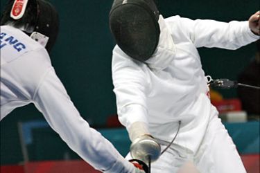 f_China's top seed Wang Lei (L) scores a point against Kazakhstan's Mirsalt Mirdjaliev during the men's individual epee preliminary rounds at the Asian Games in Doha