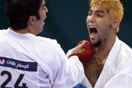 AFP/Kuwaiti Mohammad Ahmad (R) fights with Iranian Ismail Tark in the men's karate kumite -80kg semifinal during the 15th Asian Games in Doha, 13 December 2006. Kuwait beat Iran 5-4. AFP