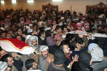 r_Supporters carry the Iraqi flag-draped coffins of Saddam Hussein's half-brother Barzan Ibrahim al-Tikriti (L) and former judge Awad Hamed al-Bander during a funeral