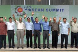 The foreign ministers of the Association of Southeast Asian Nations pose for a group picture at the opening of the ASEAN Ministerial Meeting within the 12th ASEAN Summit
