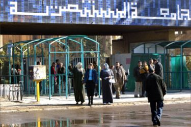 Mustansiryah Univeristy staff members stand at the entrance of the university in Baghdad, a day after bombings targeted their workplace, 17 January 2007. Seventy people, including students and teachers, were killed yesterday in the most devastating Iraq attack this year as a suicide bomber and a car bomb wreaked havoc outside the university