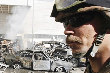 AFP / An Iraqi army soldier secures the site where a car bomb exploded in central Baghdad 12 February 2007, ripping through popular Shiite market areas and killing at least 60 people and wounding more than 150, security officials said.