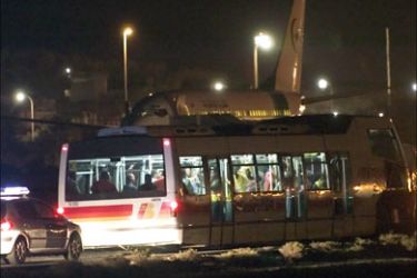 r_Passengers who were freed from a hijacked Air Mauritania Boeing 737 passenger plane are transported in a bus after it landed at Gando airport in Las Palmas on the island of Gran