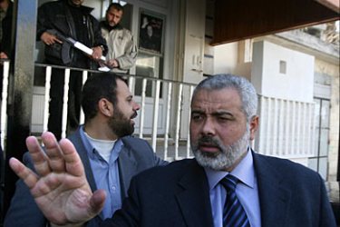 f_Palestinian Prime Minister Ismail Haniya (C) gestures as he leaves his office to meet with representatives of Palestinian factions in Gaza City, 13 February 2007