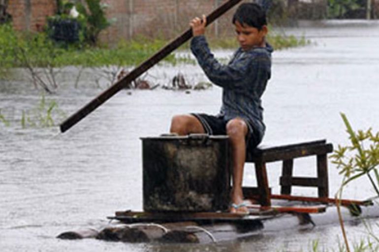 A Bolivian boy navigates his raft through flooded streets, as heavy rains attributed to the El Nino weather phenomenon continue to flood a large part of Bolivia's eastern lowlands