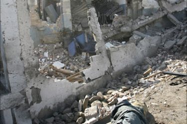 f_An Algerian man checks the rubbles of the destroyed police center of the Ben Khada town near Tizi ouzou, 90 km east of Algiers, 13 February 2007