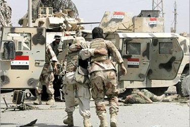REUTERS /A wounded Iraqi army soldier is evacuated by a comrade minutes after a roadside bomb exploded next to their armoured vehicle in Baghdad's northwest Sunni neighbourhood of Ghazaliya March 29, 2007. Three Iraqi