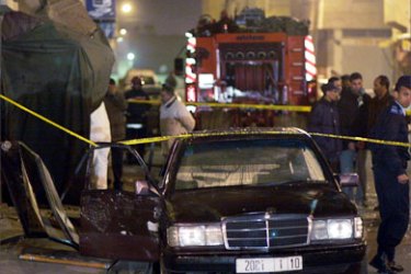 Members of a bomb squad inspect the scene of an explosion at an Internet cafe in Casablanca March 12, 2007