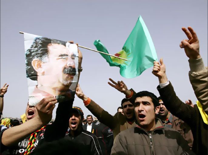 Kurdish men hold a Kurdistan Workers Party PPK flag and picture of Kurdish rebel leader Abdullah Ocalan during celebrations marking the Kurdish New Year 'Noruz' in Istanbul's Kazlicesme District, 21 March 2007.