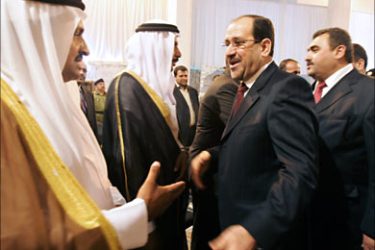 f_Al-Anbar tribe leaders greet Iraqi Prime Minister Nur al-Maliki (C) and the governor of Al-Anbar, Maamoun Sami Rashid al-Alwani (R) in Ramadi 13 March 2007.