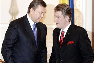 REUTERS /Ukaine's President Viktor Yushchenko and Prime Minister Viktor Yanukovich (L) speak during the security council session in Kiev, April 5, 2007. Yushchenko on Thursday threatened to prosecute his prime minister if he refused to take part in a new election, escalating a standoff paralysing