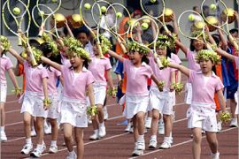 AFP / Chinese elementary school children march in their tennis outfits as they stage a mini Olympic games at a stadium in Beijing, 30 April 2007, as to show their Olympic and