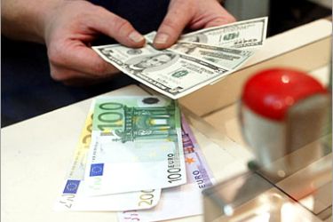 AFP (FILES) Picture dated 18 December 2003 of a change employee counting US dollar notes for Euros in Paris. The European single currency jumped to an historic peak of